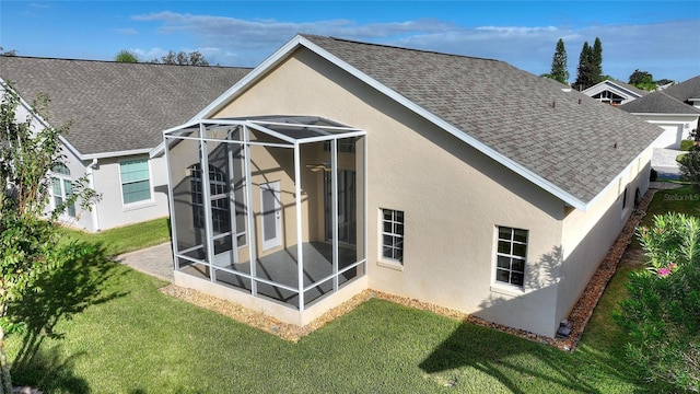 back of house featuring a yard and a sunroom