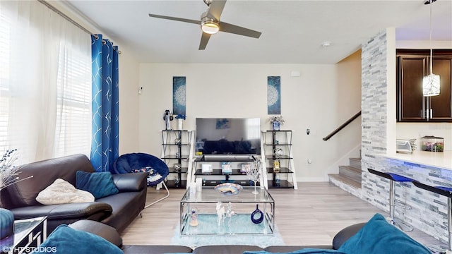 living room featuring light hardwood / wood-style flooring and ceiling fan