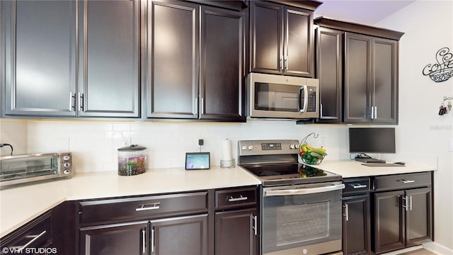 kitchen featuring tasteful backsplash, stainless steel appliances, and dark brown cabinets