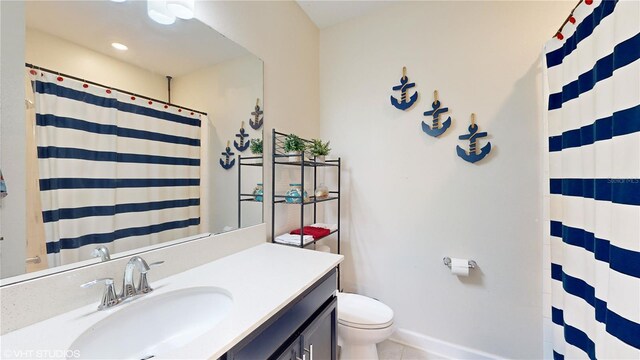 bathroom with vanity, toilet, tile patterned floors, and a shower with shower curtain