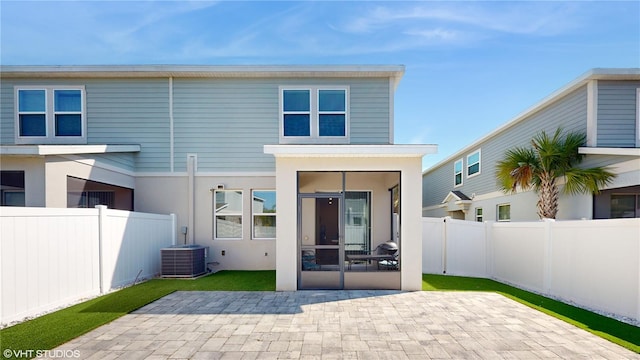 back of property featuring central air condition unit and a patio area