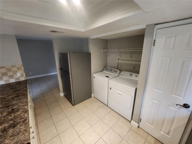 washroom with independent washer and dryer and light tile patterned floors