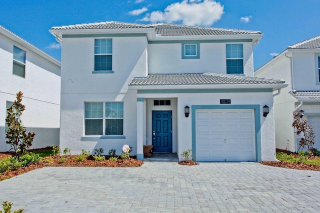 mediterranean / spanish-style house featuring a garage