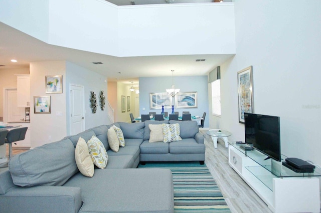 living room with a chandelier and light hardwood / wood-style flooring