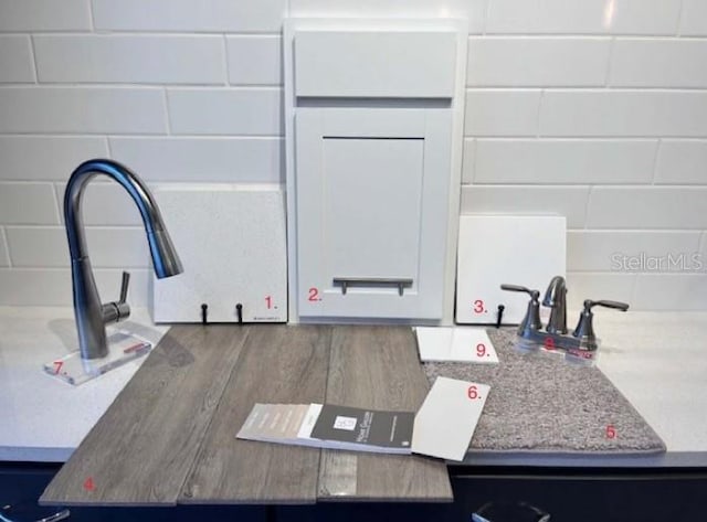 room details with white cabinets and light stone countertops