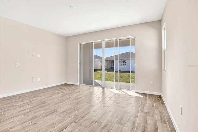 spare room featuring light wood-type flooring