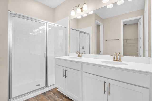 bathroom with a shower with door and vanity