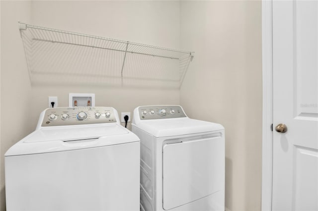 laundry room featuring separate washer and dryer