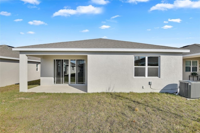 rear view of house with a yard, central AC, and a patio area