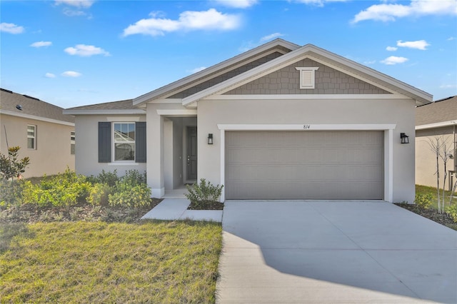 view of front of property with a garage and a front lawn