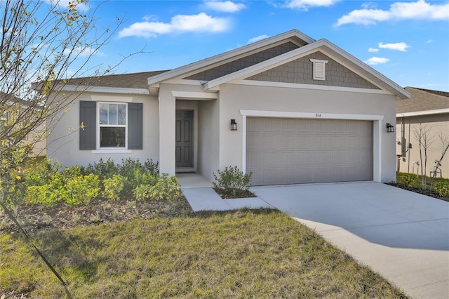 view of front of property featuring a garage and a front lawn