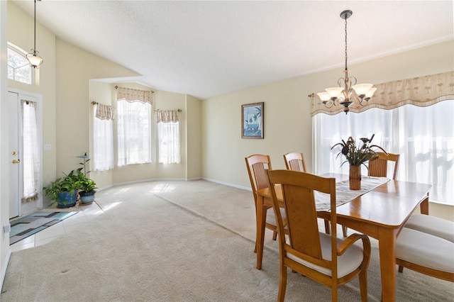 carpeted dining space featuring an inviting chandelier and lofted ceiling