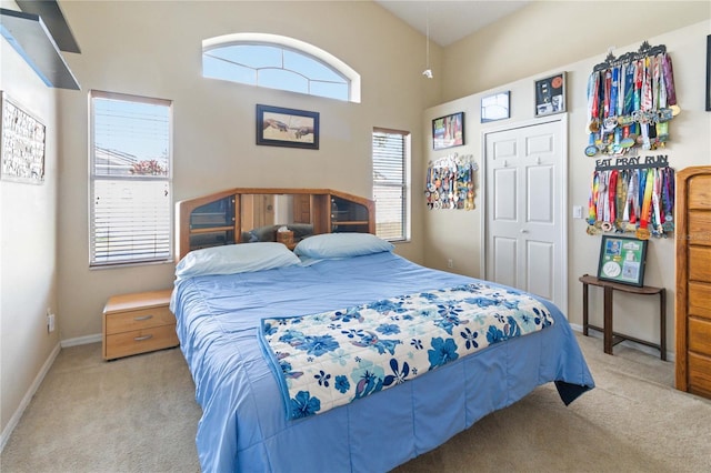 bedroom featuring light carpet and a closet