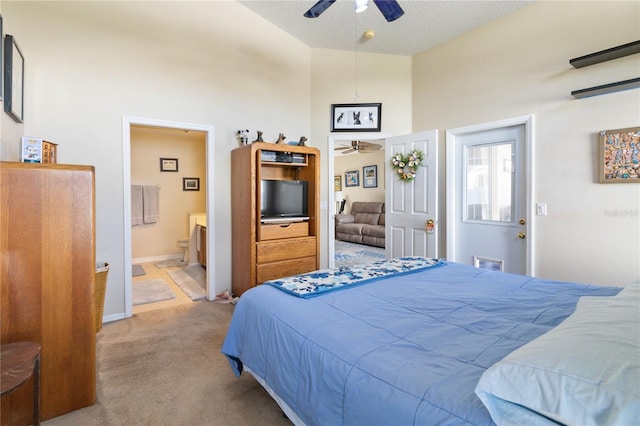 bedroom featuring light carpet, ensuite bath, a textured ceiling, a towering ceiling, and ceiling fan