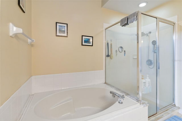 bathroom featuring separate shower and tub