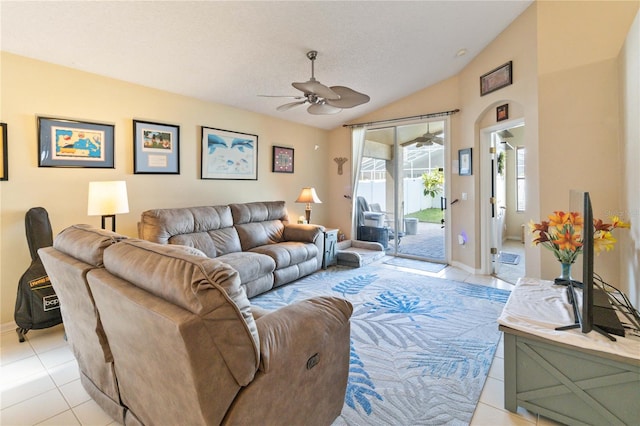 tiled living room featuring ceiling fan, a textured ceiling, and lofted ceiling