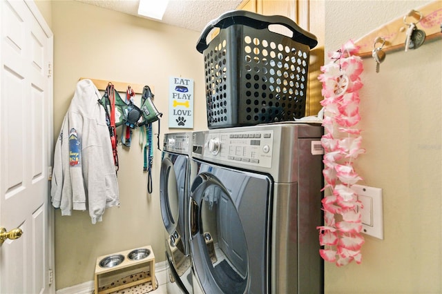 washroom featuring independent washer and dryer and a textured ceiling