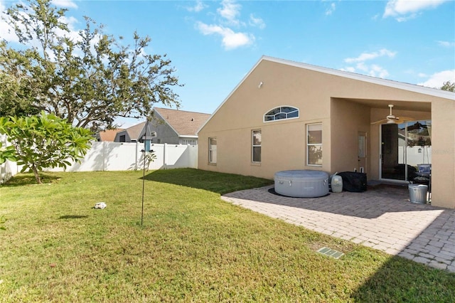 back of property featuring a yard, a patio area, and ceiling fan