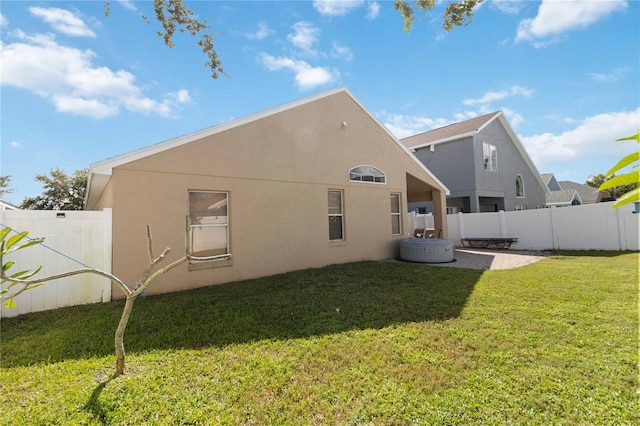 back of house with a lawn