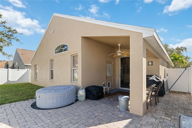 rear view of property with a patio and ceiling fan