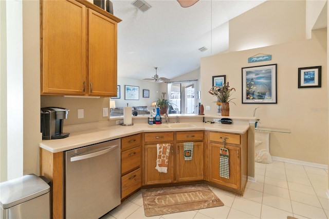 kitchen featuring lofted ceiling, dishwasher, kitchen peninsula, and light tile patterned floors