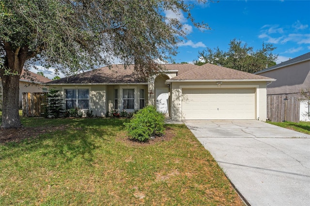 ranch-style home with a front lawn and a garage