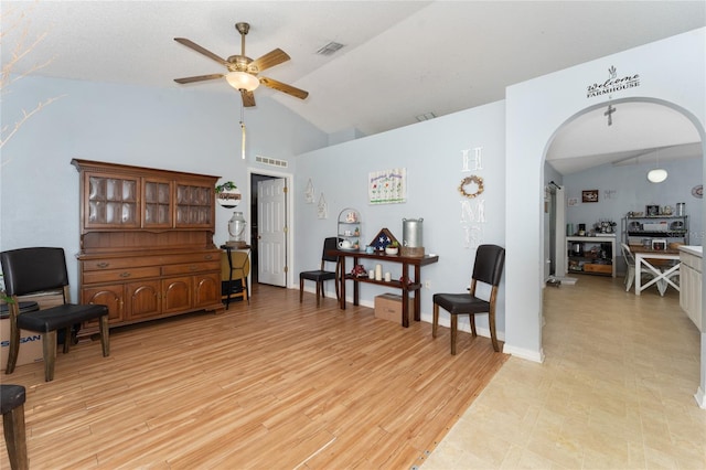 living area featuring ceiling fan, lofted ceiling, and light hardwood / wood-style floors