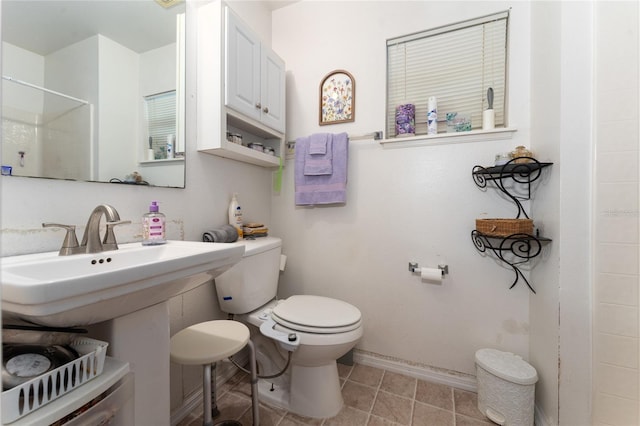 bathroom featuring a shower, toilet, and tile patterned flooring