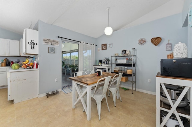 dining room with lofted ceiling