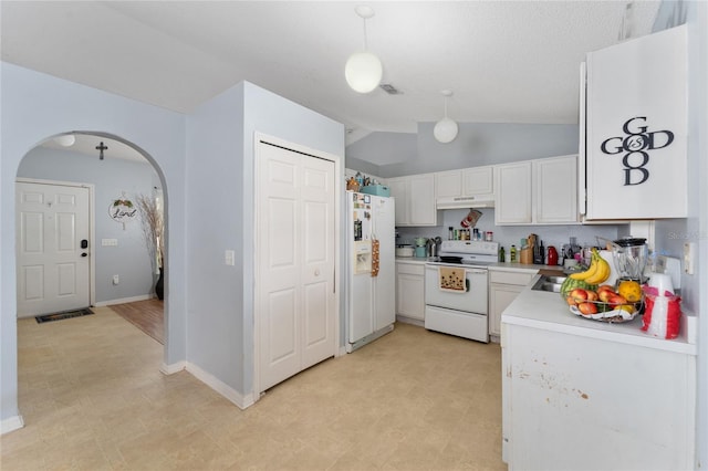 kitchen with lofted ceiling, white cabinets, pendant lighting, and white appliances