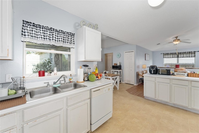 kitchen with dishwasher, white cabinets, sink, and ceiling fan