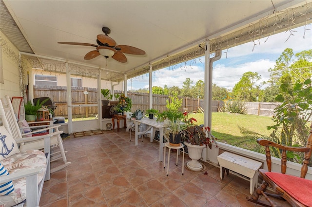 sunroom / solarium featuring ceiling fan