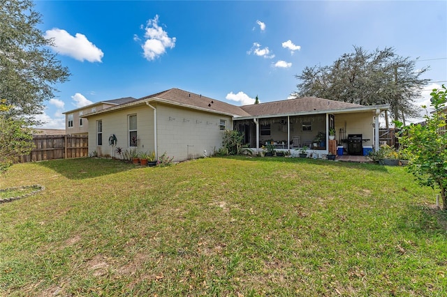 back of house with a patio area and a yard