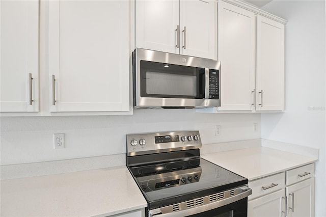 kitchen featuring appliances with stainless steel finishes and white cabinets