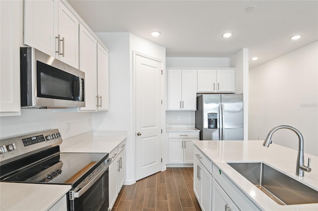 kitchen with white cabinetry, sink, and appliances with stainless steel finishes