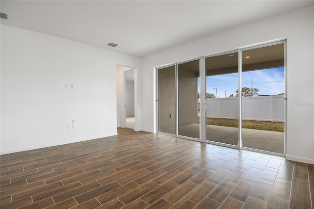 spare room featuring dark hardwood / wood-style flooring