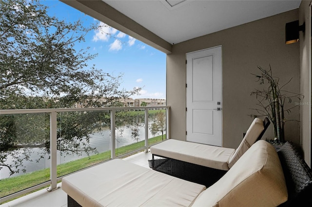 balcony with outdoor lounge area and a water view