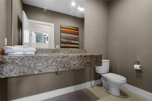 bathroom with toilet and tile patterned flooring