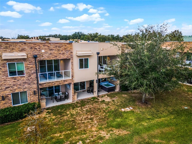 back of property with a patio and a lawn