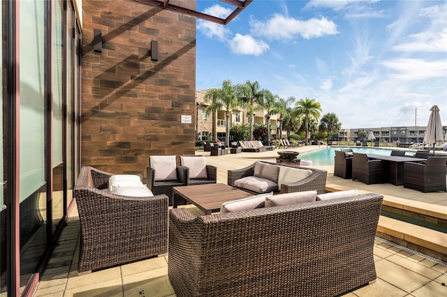 view of patio / terrace with a community pool and outdoor lounge area