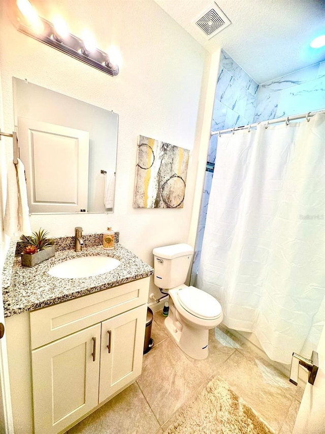 bathroom with vanity, toilet, and walk in shower