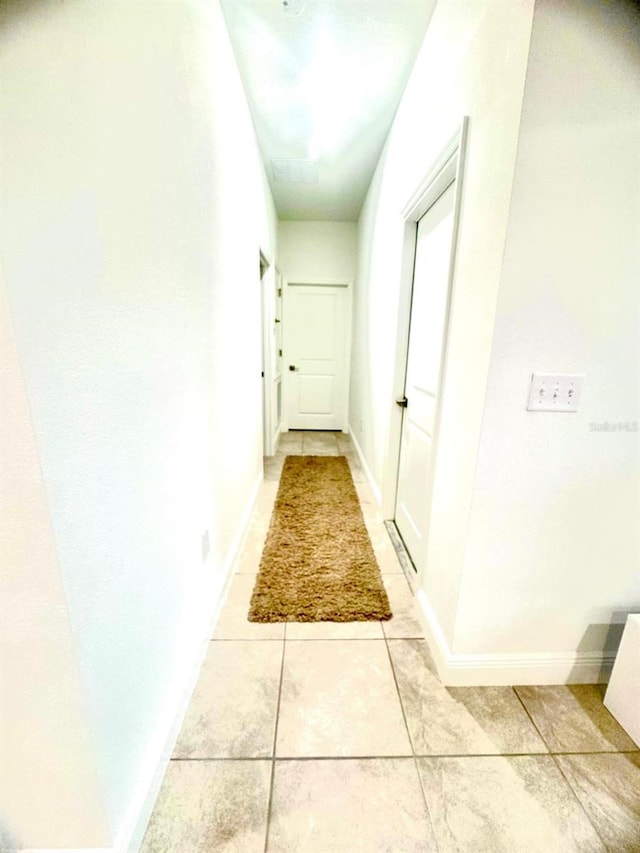 hallway with light tile patterned flooring