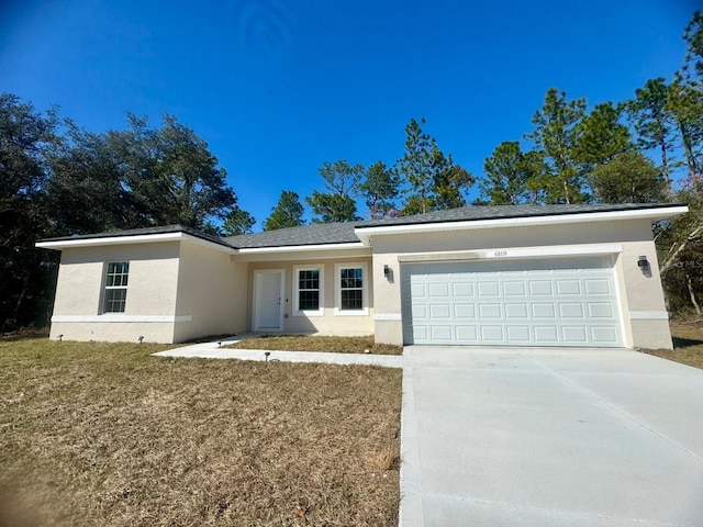 ranch-style house with a garage and a front yard