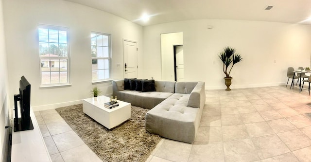 tiled living room with lofted ceiling