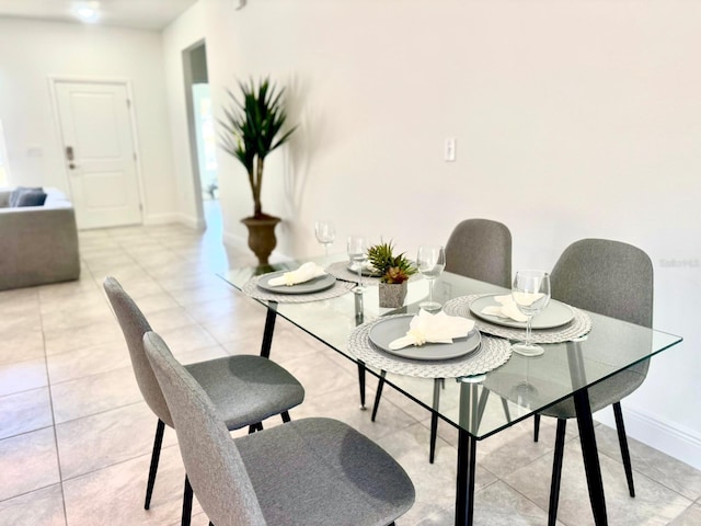 dining space featuring light tile patterned floors