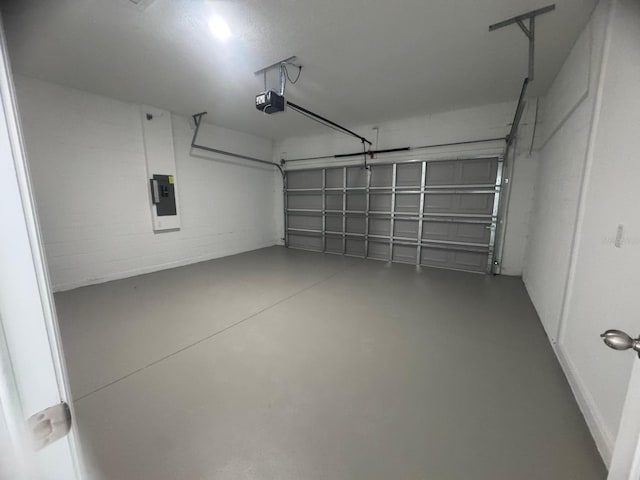 garage featuring a garage door opener and electric panel