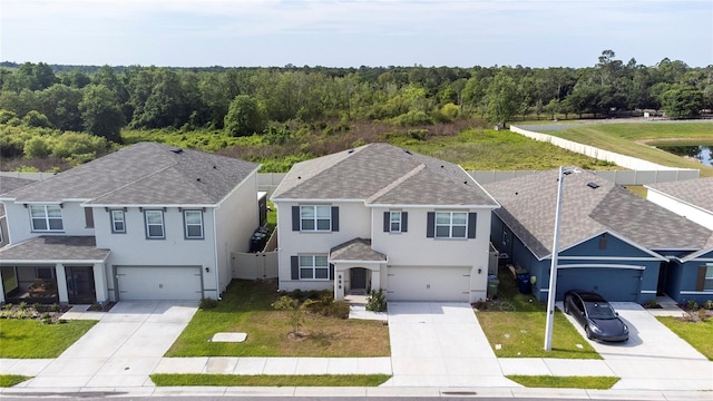 view of front of property featuring a front yard and a garage