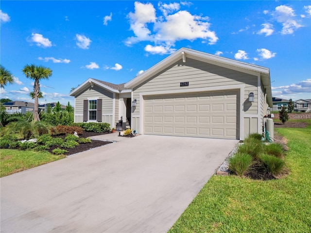 single story home with concrete driveway, an attached garage, and a front yard