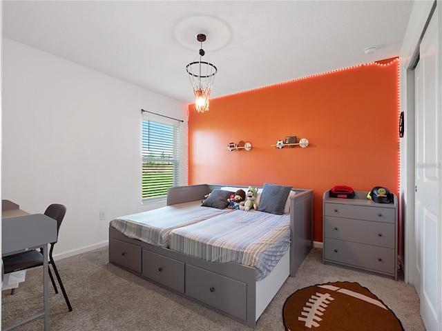 carpeted bedroom featuring an inviting chandelier