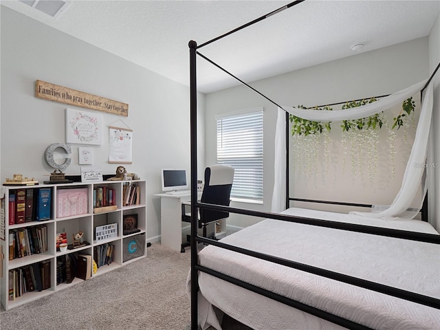 bedroom with a textured ceiling and carpet flooring